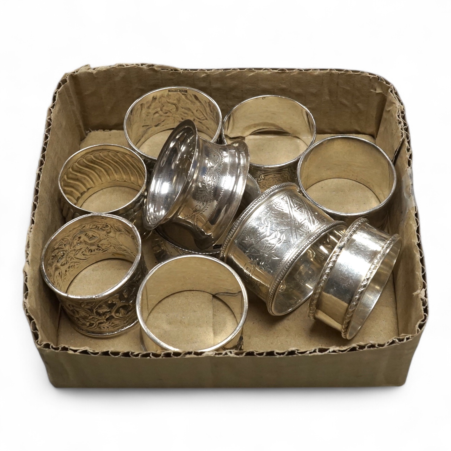 Six assorted silver napkin rings including late Victorian by Walker & Hall, Sheffield, 1894 and four other white metal napkin rings including Indian. Condition - fair